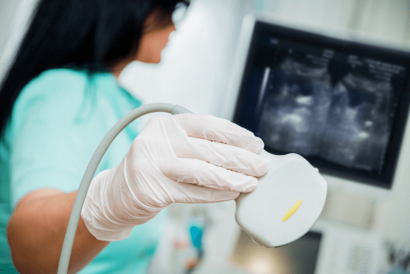 Clinician performing an ultrasound examination.